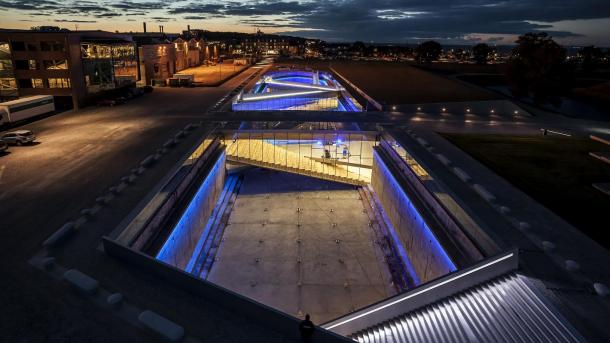 The Danish Maritime Museum in Helsingør, Denmark, lit up at night with neon lights